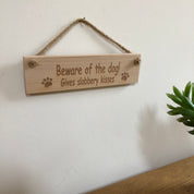 Wooden plaque - beware of the dog - gives slobbery kisses