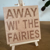 Wooden coaster gift - Scottish dialect - away wi' the fairies - displayed on an easel