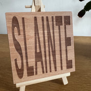 Wooden coaster gift - Scottish dialect - slainte - displayed on an easel