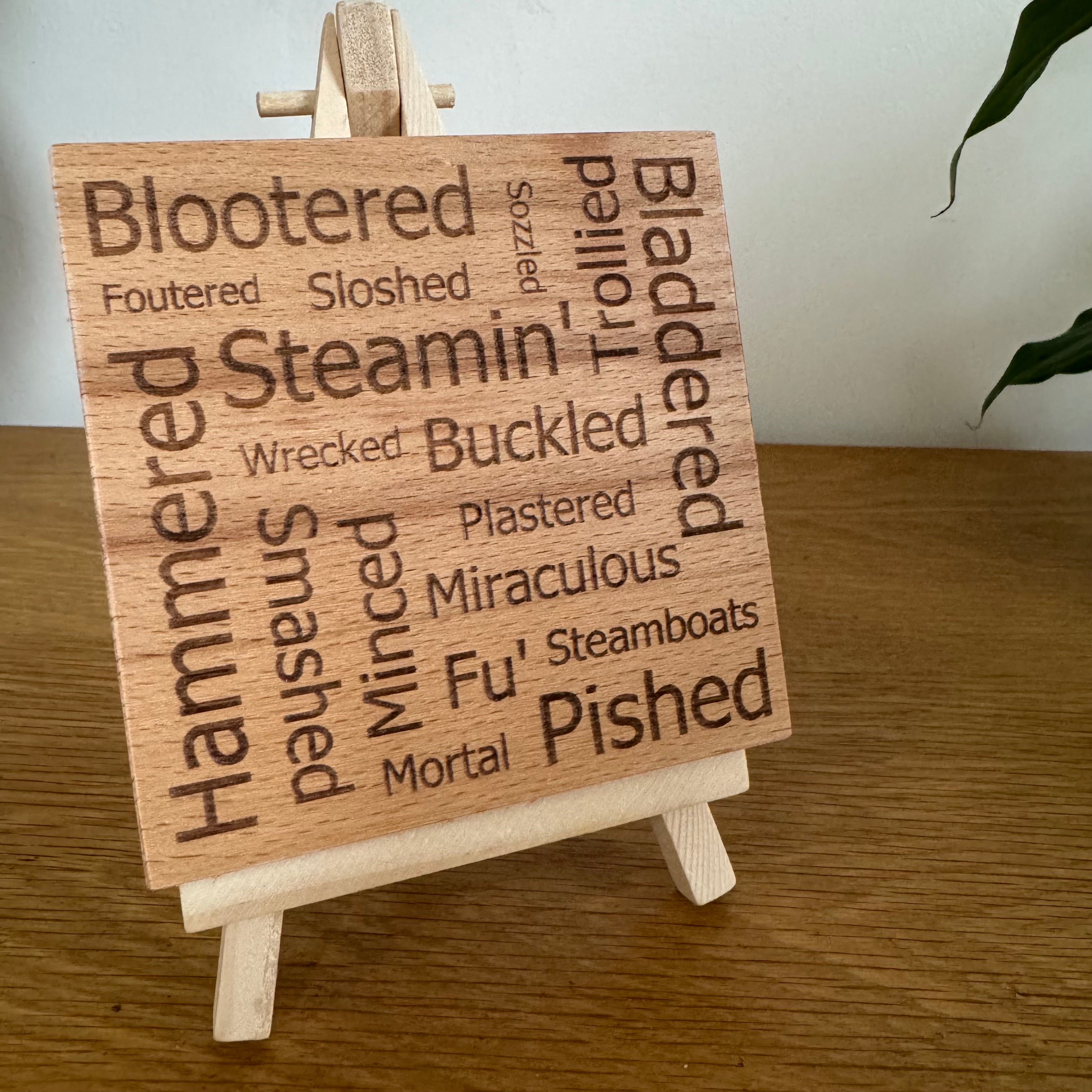 Wooden coaster gift - Scottish words for drunk - displayed on an easel