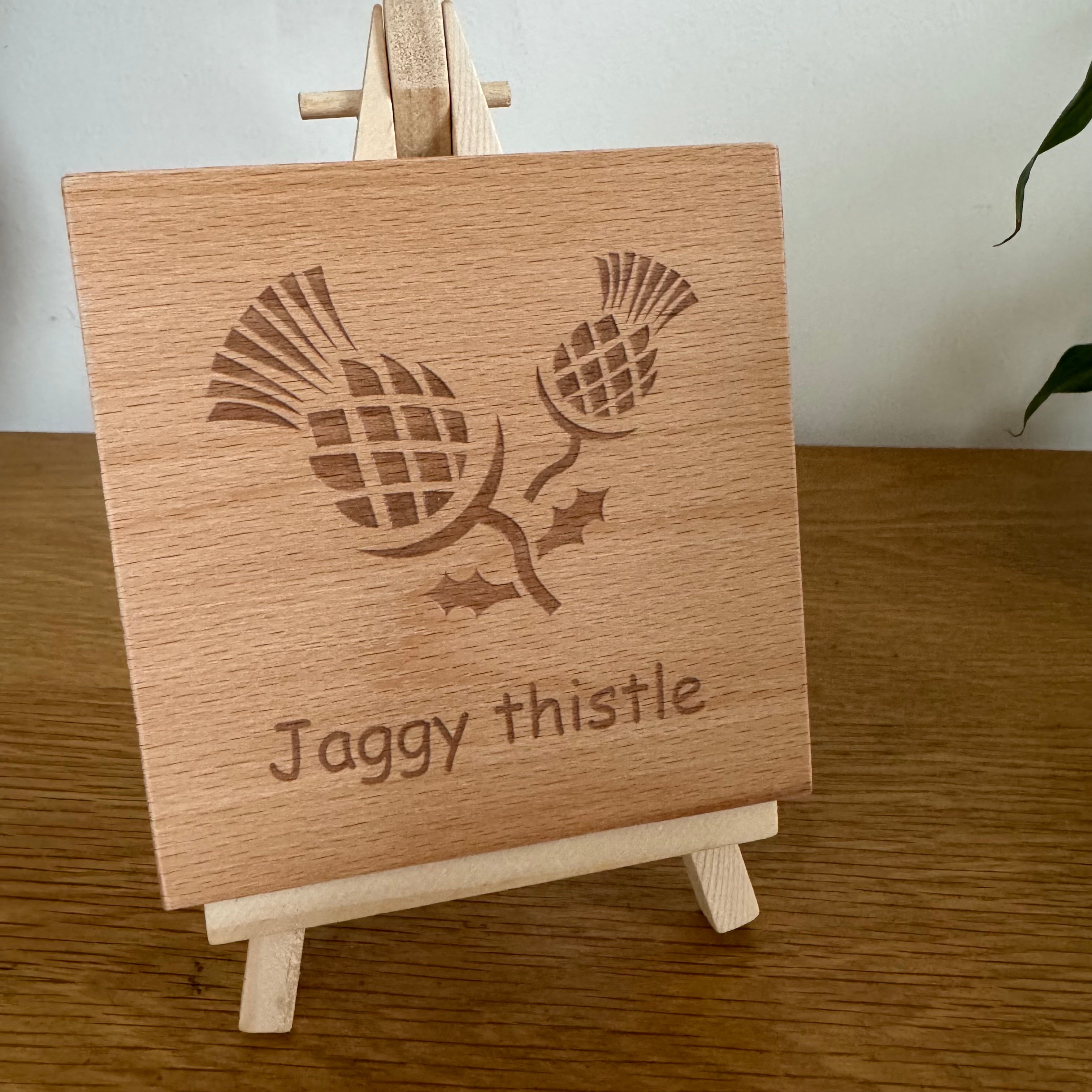 Wooden coaster gift - Scottish jaggy thistle - displayed on an easel