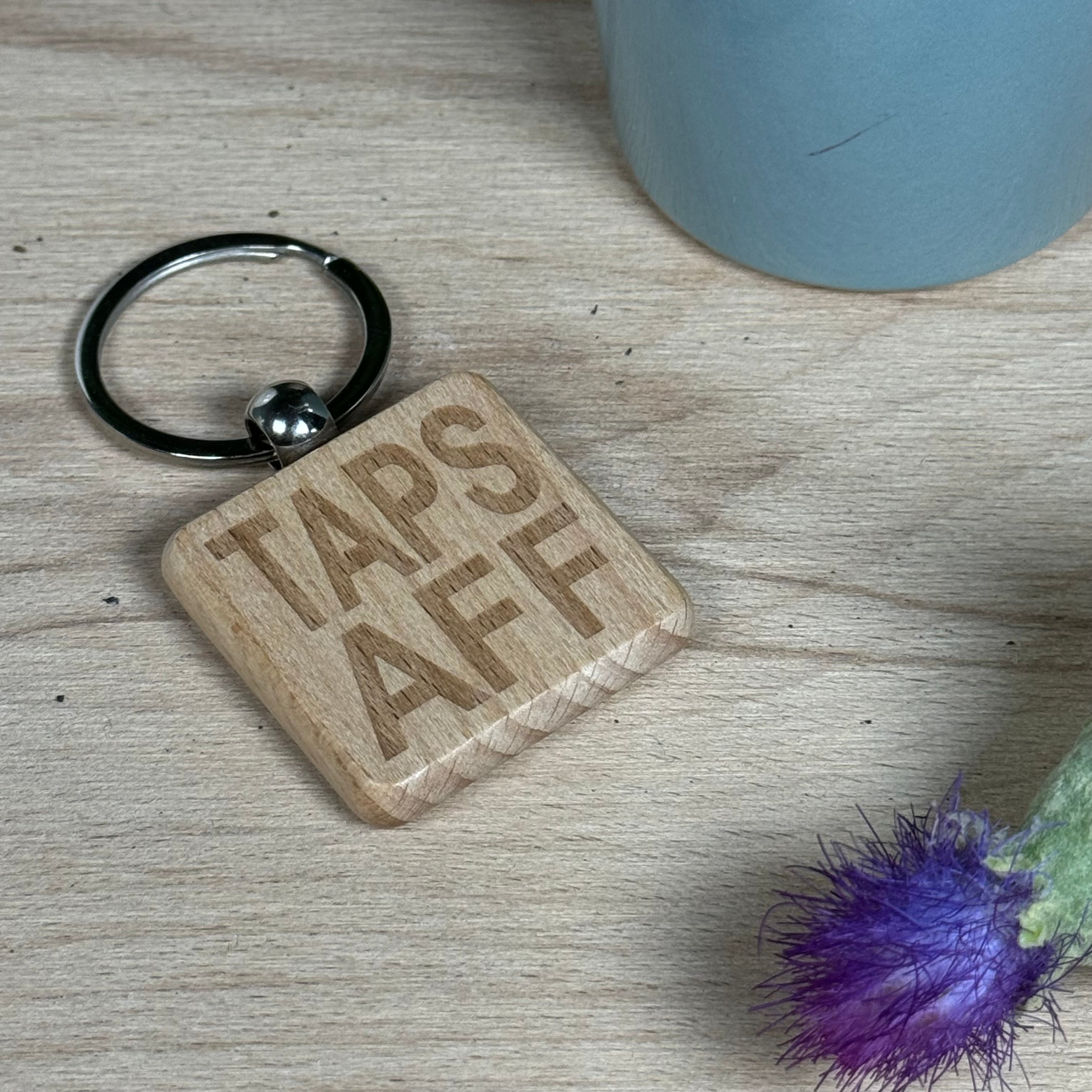 Wooden keyring laser engraved with Scottish dialect - taps aff